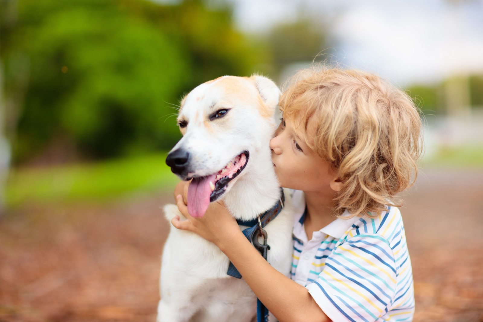 A child quietly hugging the dog they grew up waiting for